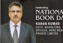 World Book Day | Karan Kumar on ‘Thinking, Fast and Slow’ Karan Kumar in a suit on a MediaBrief banner celebrating National Book Day, with his title and company listed against a backdrop of book pages.