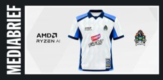 White and blue sports jersey with sponsor logos AMD Ryzen AI and Camp Energy, and a team crest on the right, displayed on a light backdrop.