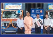 AWL Agri Business donates food distribution vehicles to Akshaya Patra Foundation Five men and a monk stand beside a decorated blue truck at a vehicle handover ceremony; banners show Fortune and Akshaya Patra logos.