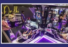 Formula 1 Sim Racing India receives a massive turnout at Delhi People try out motion-simulation racing cabins at a tech expo, with screens displaying gameplay inside a purple-lit booth
