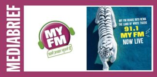 Media brief banner: My FM logo with headphones on the left; blue promotional banner with a tiger and '91.1 MY FM Now Live' on the right.