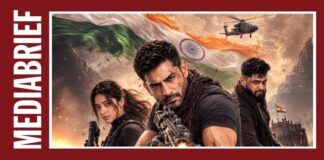 Film poster showing three armed protagonists in a dramatic battlefield scene, with the Indian flag in the sky and a helicopter overhead.